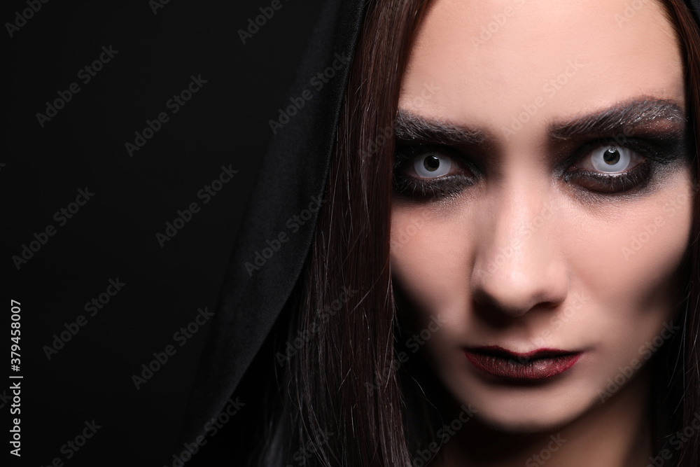 Mysterious witch with spooky eyes on black background, closeup. Space for text Mysterious witch with spooky eyes on black background, closeup. Space for text