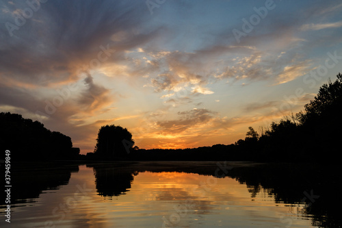 Sunset over wetland of Danube river with mirror reflection in water surface, Slovakia © Miroslav