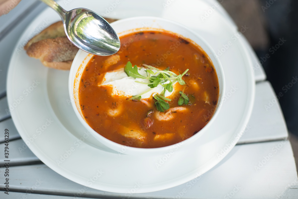 Tomato soup with seafood in a white plate. Tomato soup with seafood in a white plate.
