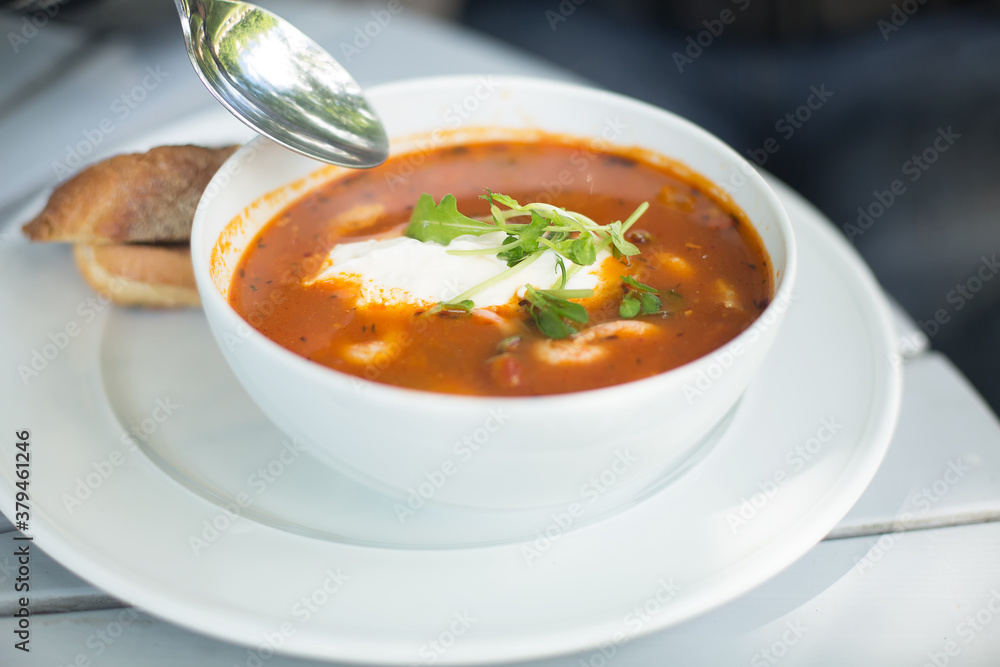 Tomato soup with seafood in a white plate. Tomato soup with seafood in a white plate.