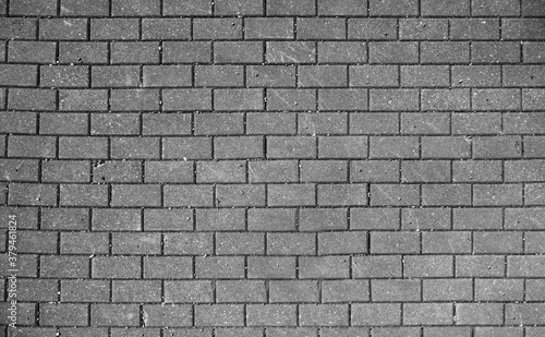 Stretcher bond type brick wall in black and white photo, paving stones pattern, colorless background