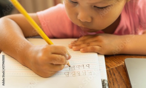 Slika na platnu A young child learning how to write letters and alphabets, pencil and paper