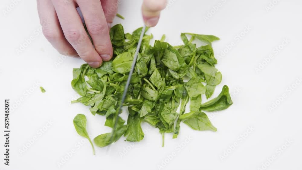 Cutting up green fresh spinach Cutting up green fresh spinach