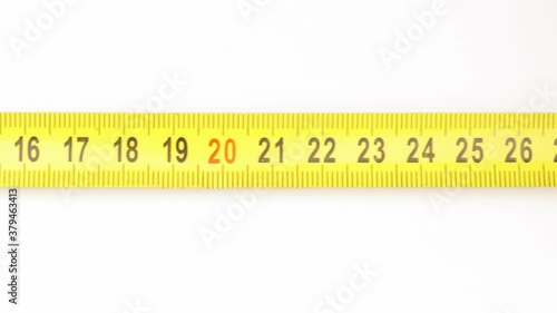 Extending measuring tape on white background photo