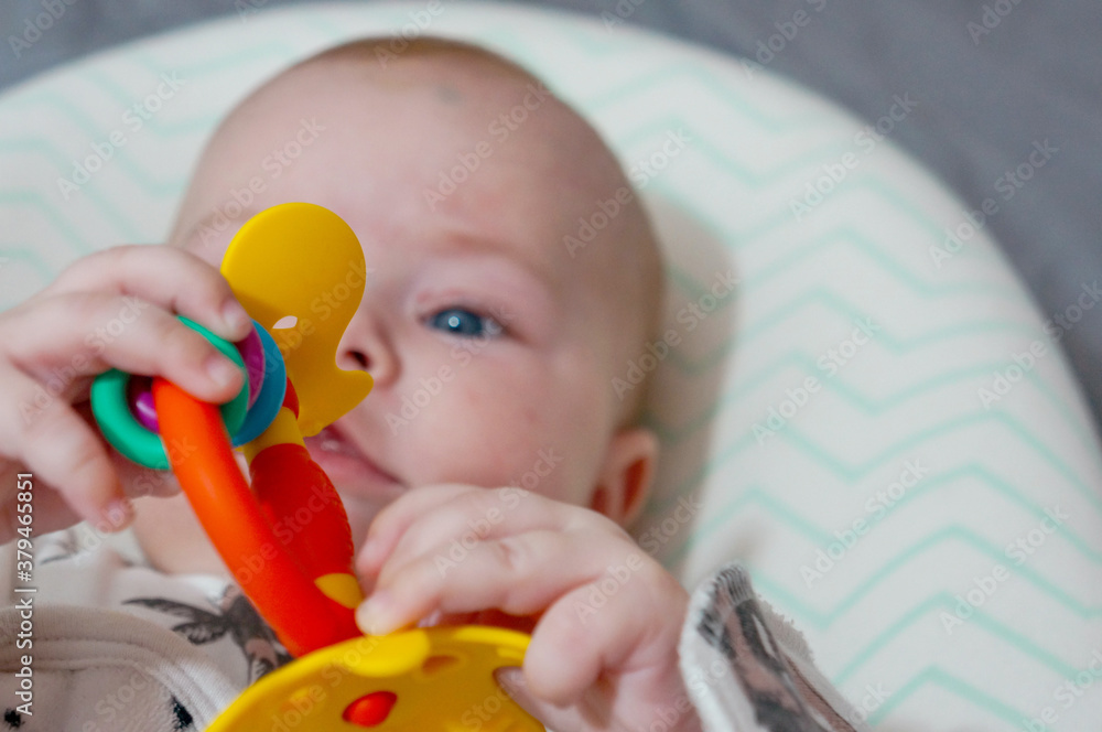 cute baby playing with a rattle close-up cute baby playing with a rattle close-up