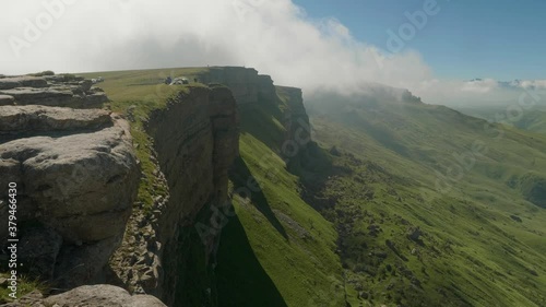 Plateau Bermamyth covered with green grass during sunny summer day. Coars and tourists are on plateau. photo