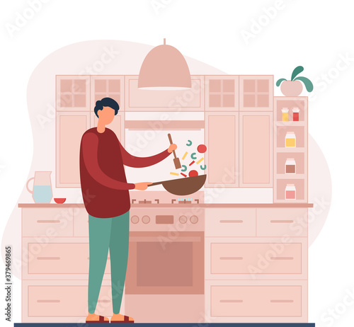 Man cooking healthy dinner in kitchen at home
