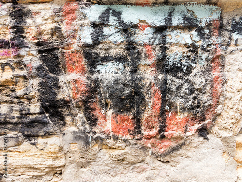 Multi-colored old paint on stone surface, as textured background. Vintage colorful background texture. Interior design texture and balckgound