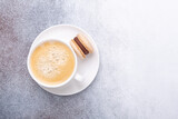 Cup of coffee and macaroon on stone background. Copy space. Flat lay, top view