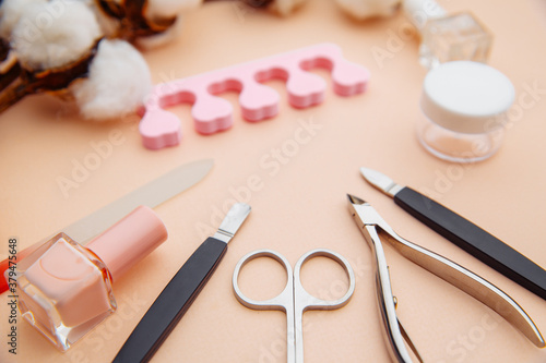 Beauty concept. A set of professional tools for manicure on pink table.