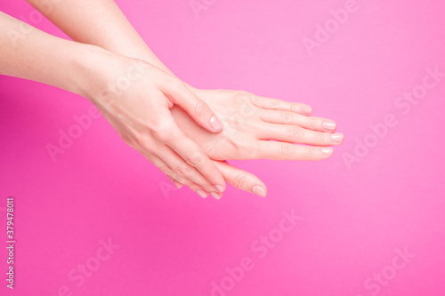 Beautiful female hands showing fresh cute manicure  skin and nail care concept  pink background