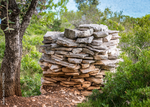 A neat pile of stones folded for the construction of the wall on the island of Lavsa, Croatia photo