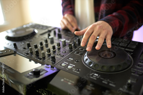 cropped dj mixes the track, perform music with the use of equipment.DJ equipment, headphones, microphones, vinyl. before the party, studio shoot