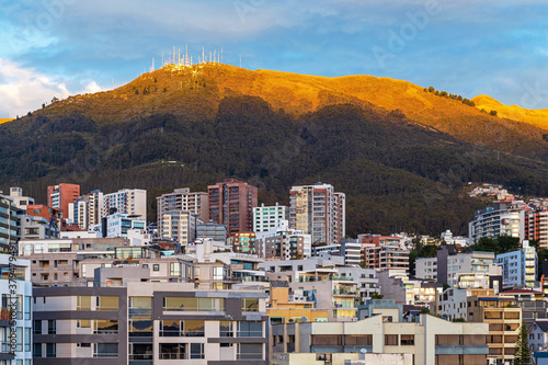 Modern apartment buildings with the Pichincha volcano at sunrise, Quito, Ecuador.