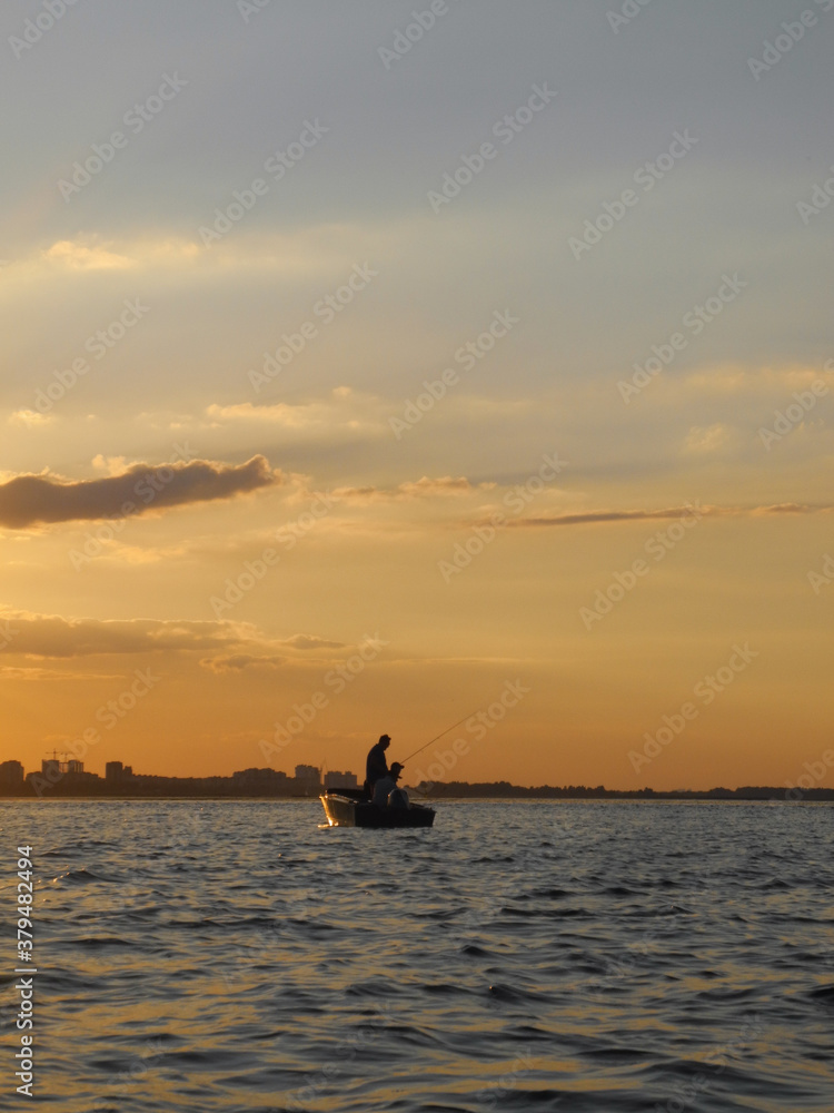 Fototapeta premium fishing boat at sunset