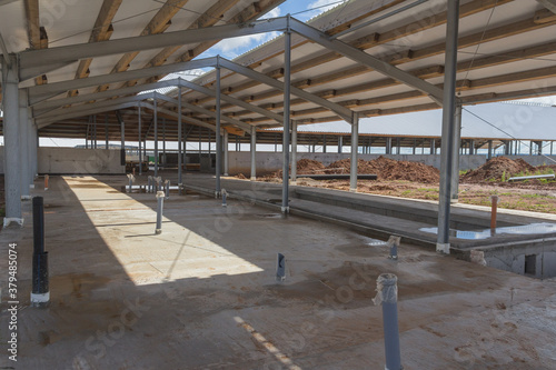 Concrete floor with building under construction. Concrete base of the floor. Construction of the hangar
