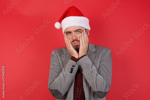 Young caucasian businessman wearing casual clothes standing over isolated red background Tired hands covering face, depression and sadness, upset and irritated for problem