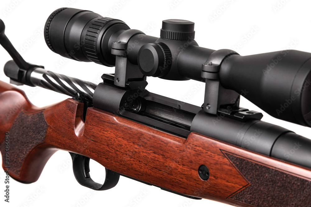Obraz premium A sniper rifle with a telescopic sight. A carbine with a wooden stock. Weapons for hunting and sports isolate on a white back.