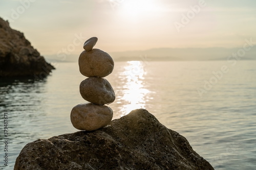 Canvas Print Rocks on the beach at sunset