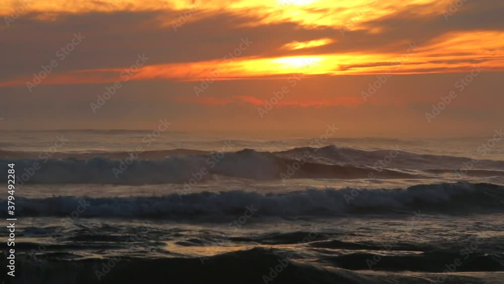 Beautiful sunrise or sunset with ocean waves and the warm light of the golden hour. Beautiful sunrise or sunset with ocean waves and the warm light of the golden hour.