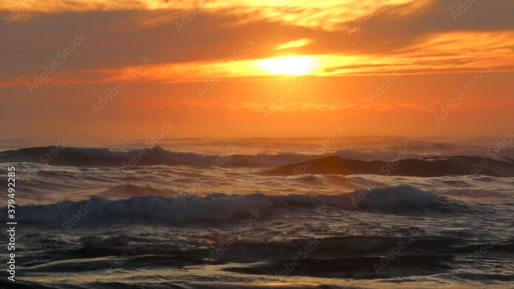 Beautiful sunrise or sunset with the calm waves of the sea and gull birds flying in the orange sky. Beautiful sunrise or sunset with the calm waves of the sea and gull birds flying in the orange sky.