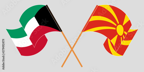 Crossed and waving flags of North Macedonia and Kuwait