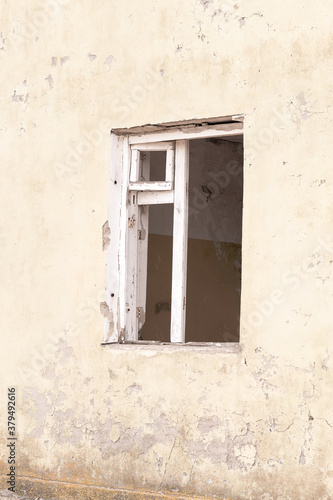 Window of an old abandoned house. Abstract concrete, weathered with cracks and scratches. Landscape style. Grunge Concrete Surface. Great background or texture.