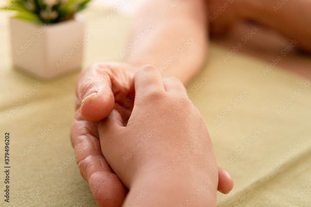 close up detail of young hands over older hand. Togetherness, multi-generation family, support concept.. close up detail of young hands over older hand. Togetherness, multi-generation family, support concept..