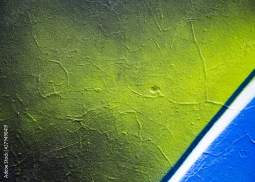 Abstract creative background of chaotic strokes of old cracked paint on concrete wall. Old surface with traces of paint, weathered, scratches and cracks for design