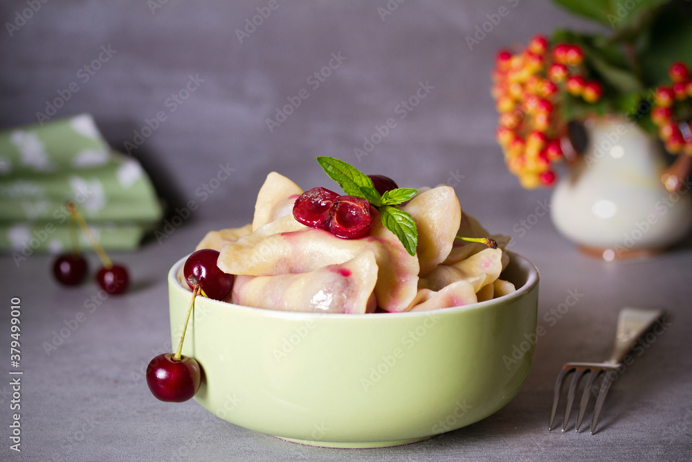 Dumplings, filled with cherries. Varenyky, vareniki, pierogi, pyrohy - popular dish in many countries.  horizontal photo