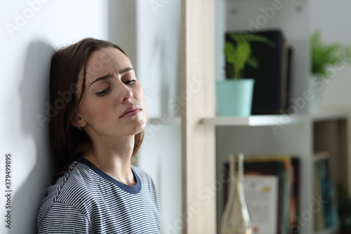 Depressed woman complaining alone at home