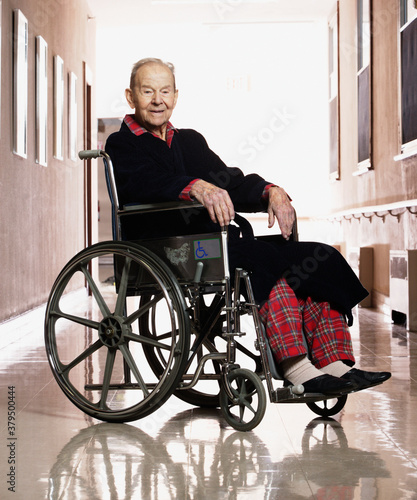 Elderly man smiling for the camera in a wheelchair