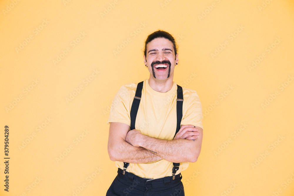 Happy man standing against yellow background Happy man standing against yellow background