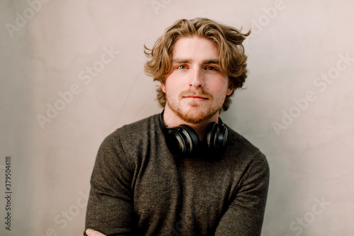 Portrait of confident businessman against wall in office photo