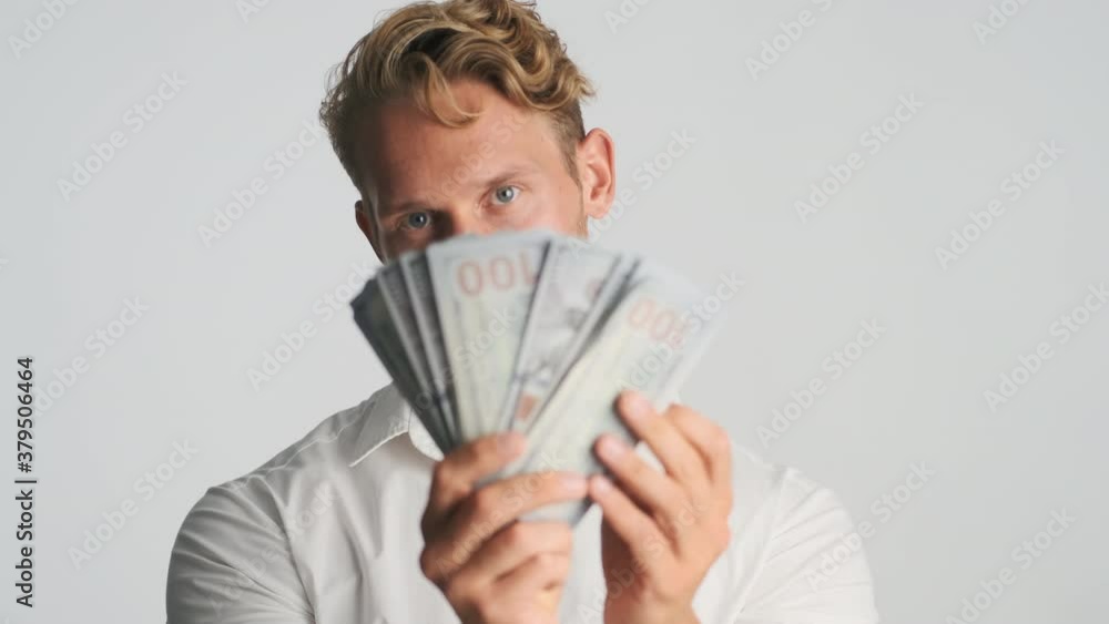 Young handsome rich bearded businessman confidently showing wad of money in camera isolated Young handsome rich bearded businessman confidently showing wad of money in camera isolated