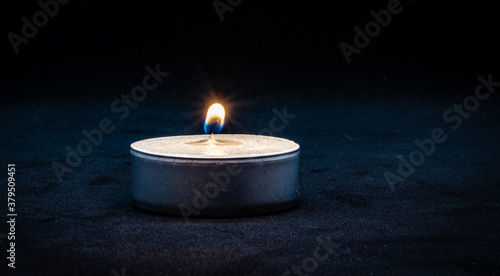 Fotografie Close up of a burning tealight candle