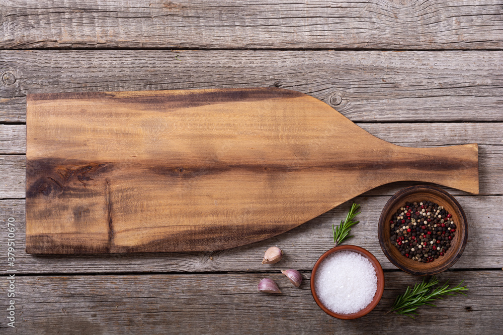 Rustic cutting board on wooden background Rustic cutting board on wooden background