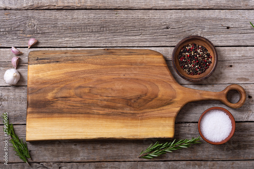 Rustic cutting board on wooden background
