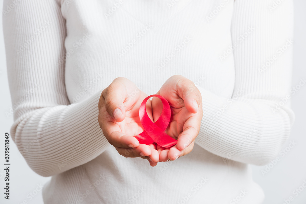 Breast cancer awareness healthcare and medicine concept. Close up Asian woman holding pink breast cancer awareness ribbon on hands treatment charity, studio shot isolated on white background Breast cancer awareness healthcare and medicine concept. Close up Asian woman holding pink breast cancer awareness ribbon on hands treatment charity, studio shot isolated on white background
