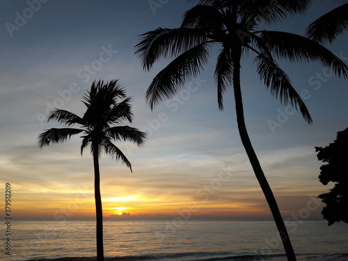 Maceió - Alagoas - Brazil - March 22, 2019 - Sunrise on the beach between coconut palms
