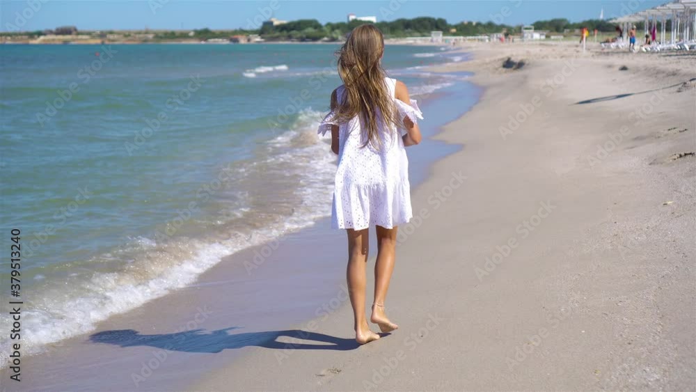Adorable little girl at beach during summer vacation Adorable little girl at beach during summer vacation