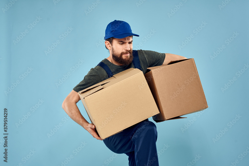 working man boxes in hands delivery service packaging lifestyle blue background working man boxes in hands delivery service packaging lifestyle blue background