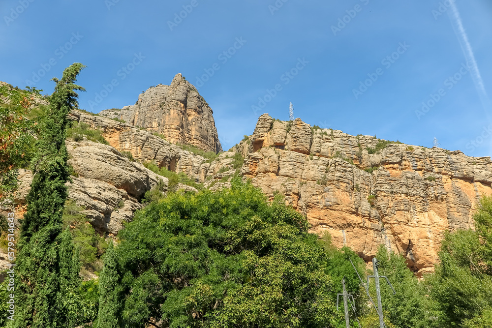 Hills with rock walls and vegetation around in the interior of Spain