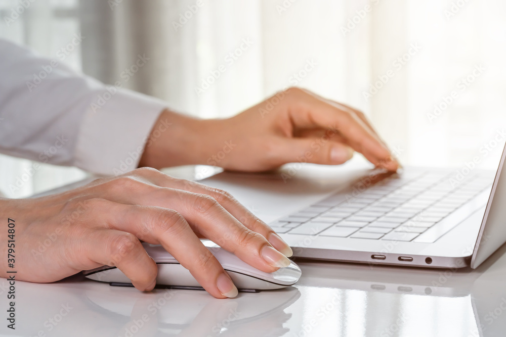 close-up female hand of business woman using mouse to working with laptop computer close-up female hand of business woman using mouse to working with laptop computer