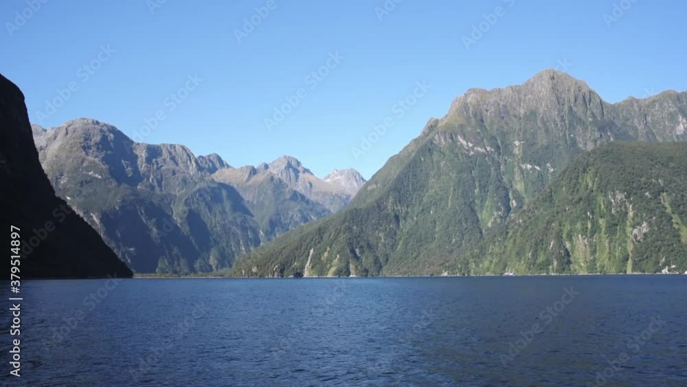 View of deep blue calm water and the towering mountains of the Doubtul Sound in New Zealand. Fiordland on the South Island View of deep blue calm water and the towering mountains of the Doubtul Sound in New Zealand. Fiordland on the South Island