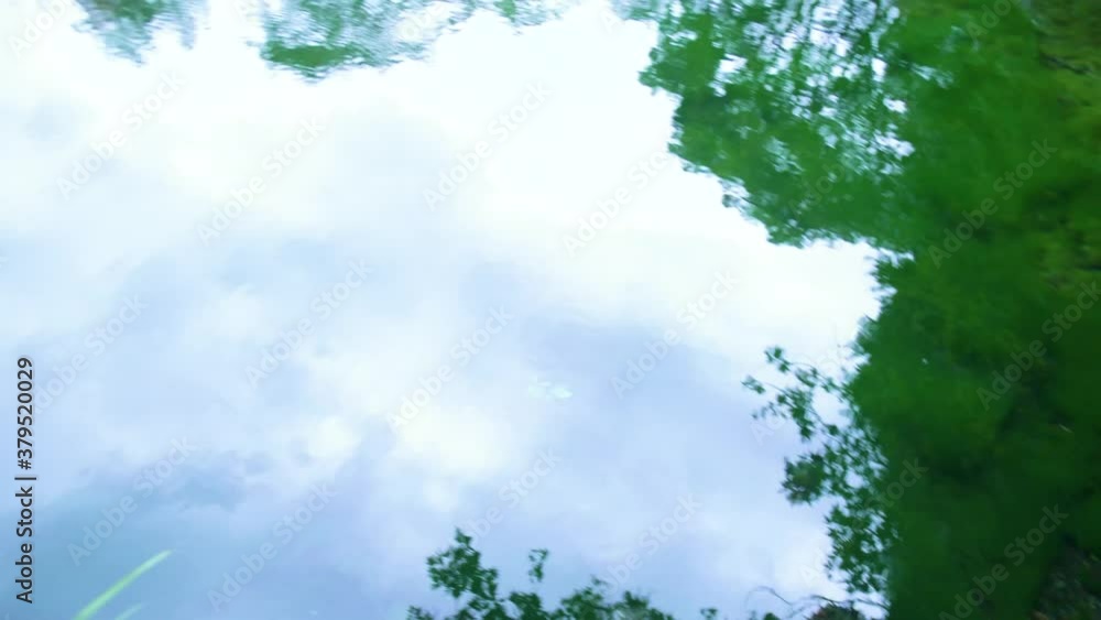 Shot of a clear pond with a small waterfall in japan