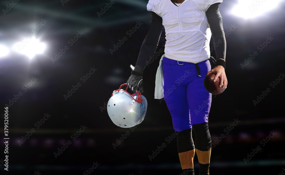 Fototapeta premium football player holding ball and helmet