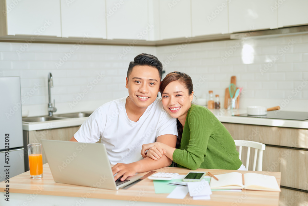Woman and man doing paperwork together, paying taxes online on notebook pc Woman and man doing paperwork together, paying taxes online on notebook pc