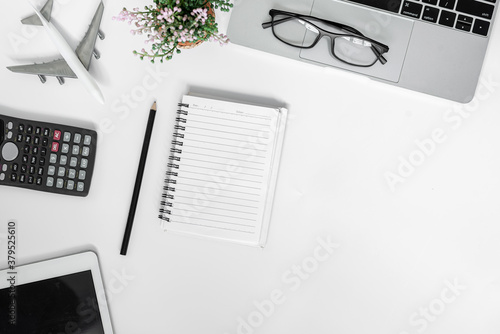 Top view copy space. Desk office with laptop, blank notepad on wood table.