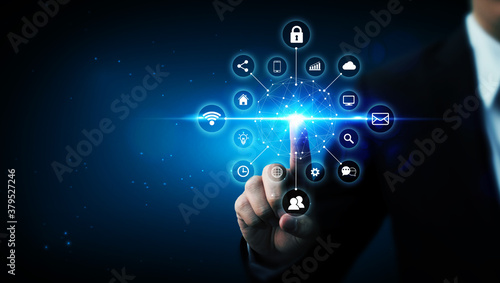 Internet of things (IOT) concept. Businessman touching solution represented by symbol connected with icon photo